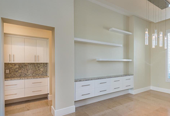 Luxury master bedroom remodel in Santa Monica featuring modern linear fireplace and stone accent wall